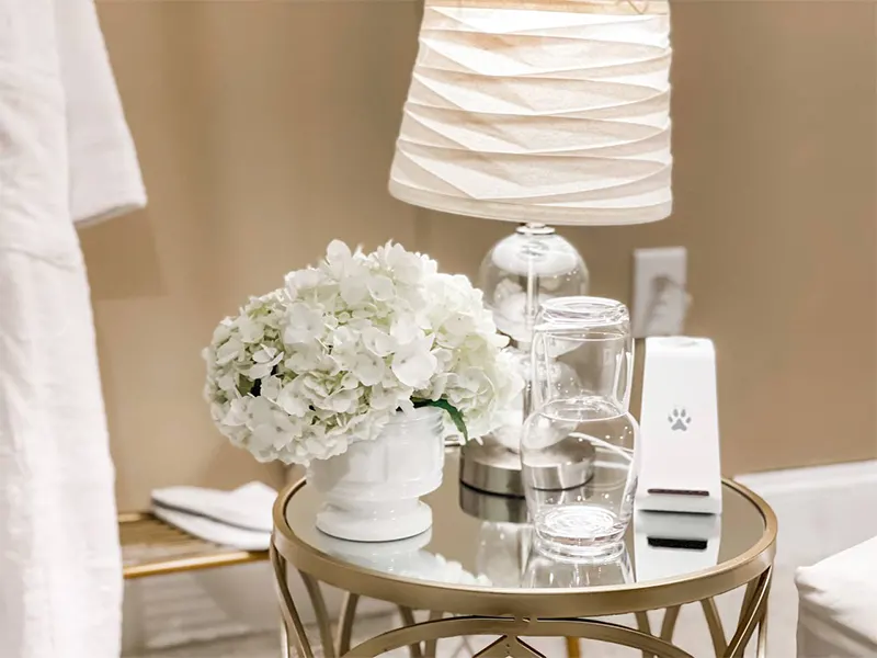 nightstand with flowers A nightstand with flowers and a glass of water | How to Create a Guest Room When You Don't Have One